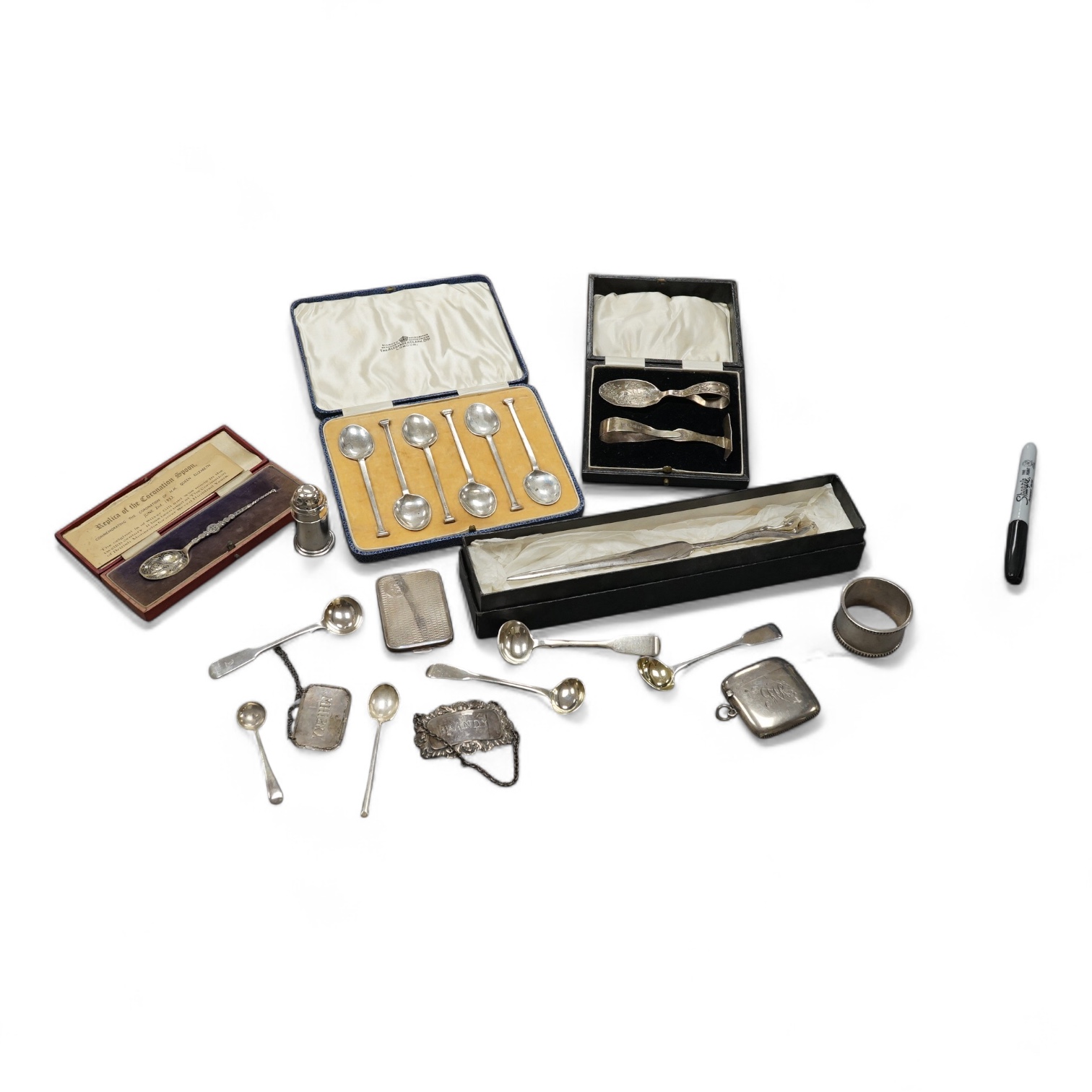 A collection of small silver items including a cased spoon & pusher, a cased set of six George V teaspoons, wine labels, vesta case, match sleeve holder, condiment spoons and a modern paper knife by Sarah Jones, London,